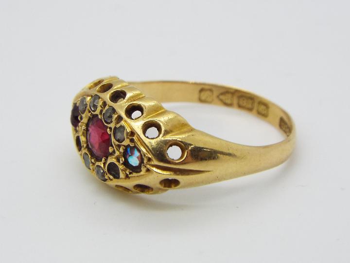A hallmarked 18ct yellow gold, stone set dress ring, size N, approximately 3.9 grams all in.
