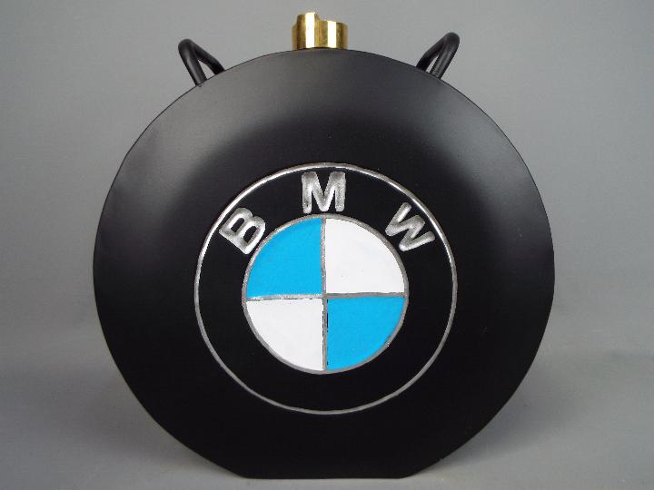 A black petrol can marked B.M.