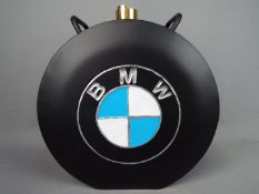 A black petrol can marked B.M.