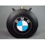 A black petrol can marked B.M.