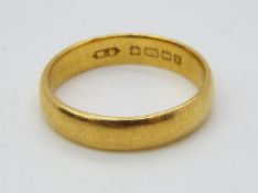 A hallmarked 22ct yellow gold wedding band, size O, approximately 4.6 grams all in.