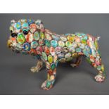 A ceramic bulldog decorated with a bottle top design,