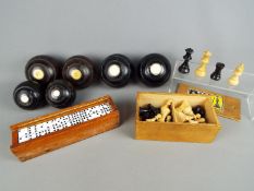 A mixed lot to include bowls, cased dominoes and chess pieces.