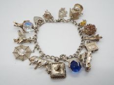 A Silver charm bracelet decorated with 14 charms