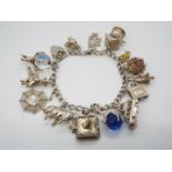 A Silver charm bracelet decorated with 14 charms