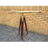 A brass telescope on wood and brass, adjustable, tripod stand,