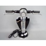 A black novelty table lamp in the form of a Vespa,