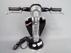 A black novelty table lamp in the form of a Vespa,