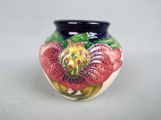 Moorcroft - a Moorcroft vase decorated in the Anna Lily pattern, approx 7.