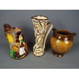 A Wade 'Gothic' pattern jug, Burleigh Ware 'Old Feeding Time' jug and a Crown Devon vase,