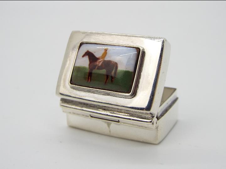A Silver pill box decorated with a horse and jockey Condition Report: Item is stamped 925