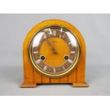 A small Smiths wood cased mantel clock with Roman numeral chapter ring, movement marked 'Smiths'.