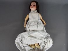 Armand Marseille German bisque porcelain doll. Makers mark: SFBJ 60 Paris. Eyelids closed.