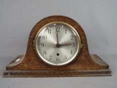 A Napoleons hat mantel clock, Arabic numerals to the dial, movement marked '14 Day British Made',