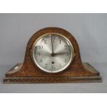 A Napoleons hat mantel clock, Arabic numerals to the dial, movement marked '14 Day British Made',