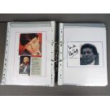 A binder containing a collection of signed photographs and press clippings to include Brian Blessed,