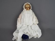 Antique Doll- wax face, arms and legs. Stuffed body with blue glass eyes.