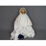 Antique Doll- wax face, arms and legs. Stuffed body with blue glass eyes.