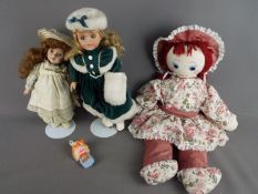 A small collection of dressed dolls and soft toys.