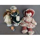 A small collection of dressed dolls and soft toys.
