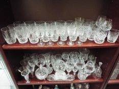 Two shelves of various glassware to include Stuart Crystal and similar.