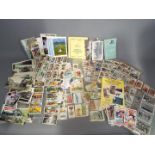 A large collection of cigarette cards and a collector's guide (1994)