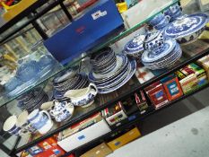 A quantity of blue and white tableware comprising, tureens, plates, side plates, cups, saucers,