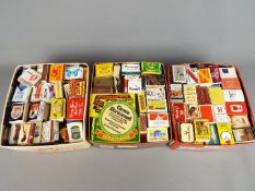 A large quantity of vintage matchboxes and matchbooks, three boxes in total.