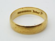 A hallmarked, 18ct yellow gold wedding band, size P, approximately 3.22 grams all in.