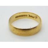 A hallmarked, 18ct yellow gold wedding band, size P, approximately 3.22 grams all in.