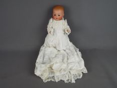 Armand Marseille German bisque porcelain doll- porcelain head and body.Moulded teeth.