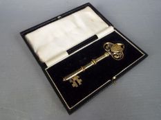 A George V silver gilt and enamel presentation key contained in fitted case, Birmingham assay 1926.