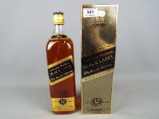 A boxed 1 litre bottle of Johnnie Walker Black Label, Extra Special 12 year old blended whisky.
