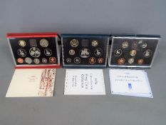 Three Royal Mint United Kingdom proof coin sets comprising 1990, 1996 and a 1997 Deluxe Proof Set,