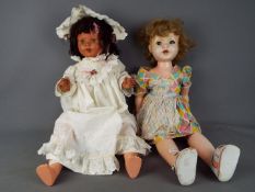 Dolls - a collection of two large composition dolls to include a girl doll with jointed head, arms,
