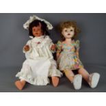 Dolls - a collection of two large composition dolls to include a girl doll with jointed head, arms,