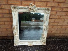 A pair of decorative wall mirrors, the frames with decoration of fairies,