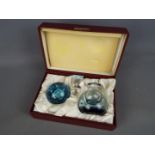 A limited edition Caithness Glass 'Quintessence' paperweight and perfume bottle set contained in