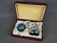 A limited edition Caithness Glass 'Quintessence' paperweight and perfume bottle set contained in