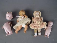 German Ceramic Dolls - a collection of four small bisque dolls ranging in size from 10 cm to 6.