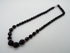 An Egyptian graduated black crystal necklace 46 cm (l)
