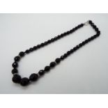 An Egyptian graduated black crystal necklace 46 cm (l)