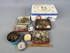 Clock Parts - a vintage tin containing three white metal pocket watches and a quantity of watch and