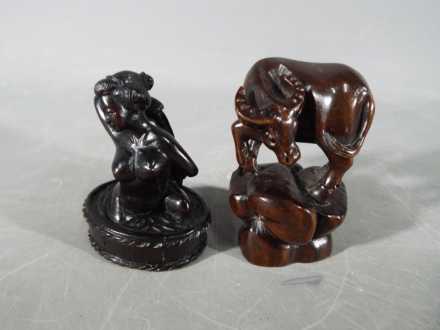 A vintage Japanese dark wood Netsuke depicting a lady bathing,