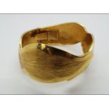 An 18ct yellow gold expanding bangle, stamped 750, approximately 33.7 grams all in.