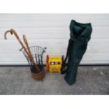 Lot to include an umbrella / stick stand with a small quantity of walking sticks,