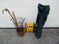 Lot to include an umbrella / stick stand with a small quantity of walking sticks,