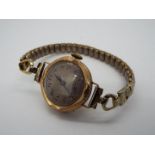 A lady's Victorian dress watch with expanding wrist strap, stamped 375 to the watch case.