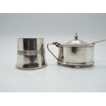 A silver plated mustard pot raised on four bun feet with spoon and a plated open salt,