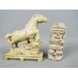 A stone carving depicting a horse, raised on plinth (approximately 16 cm height) and one further.